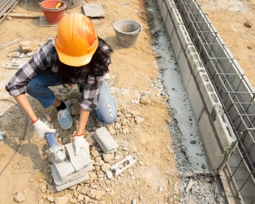 Round saw in the hands of the Builder, work on laying paving slabs. Working saws, cuts paving slab