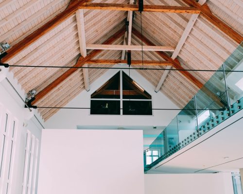 A low angle shot of a wooden ceiling in a cool house with a modern minimalistic interior