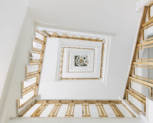 A high angle view of a modern spiral staircase in an exhibition under the lights